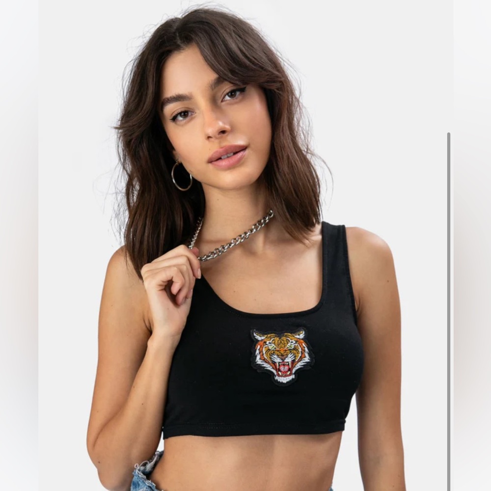 Black crop top with tiger patch, size S.